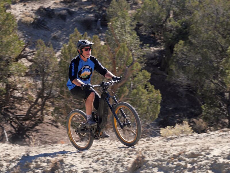 The Optibike G2 climbing up a steep hill, with the rider looking like they're having an easy time.